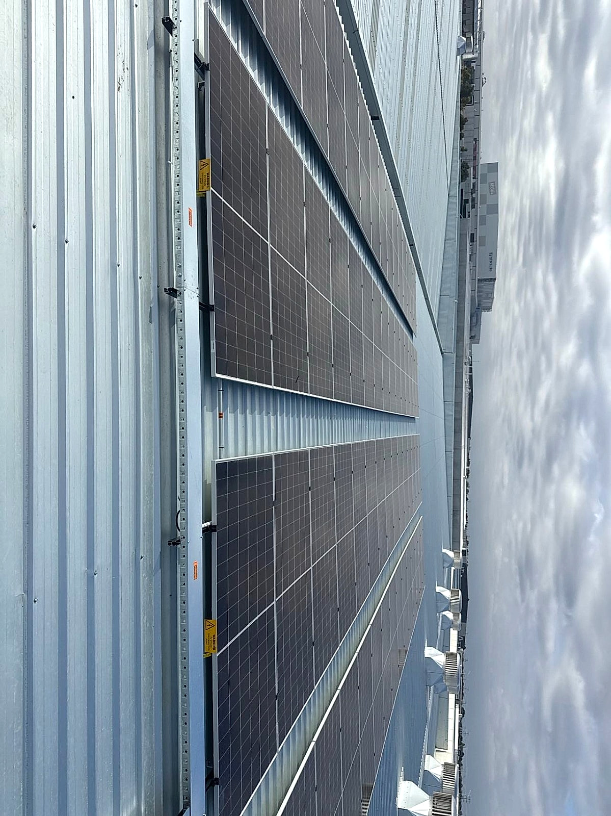 Large-scale commercial solar panels on warehouse wall