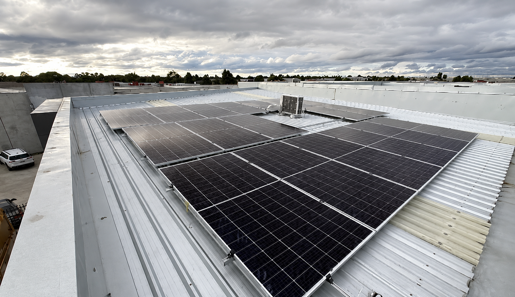Completed commercial solar panel array on warehouse flat roof